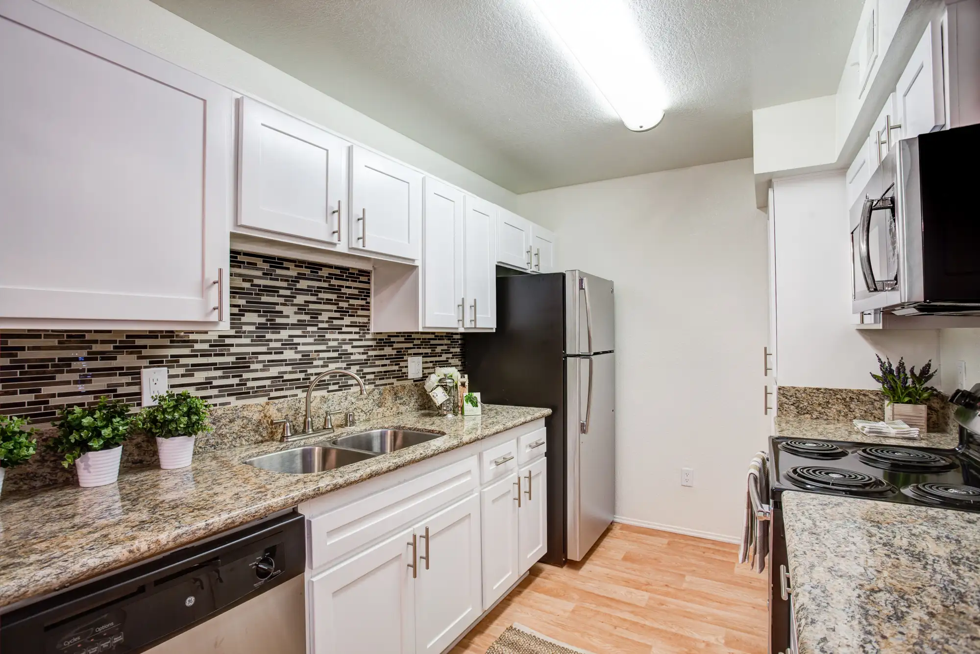 Waterstone Alta Loma Apartments kitchen with stainless steel appliances and backsplash