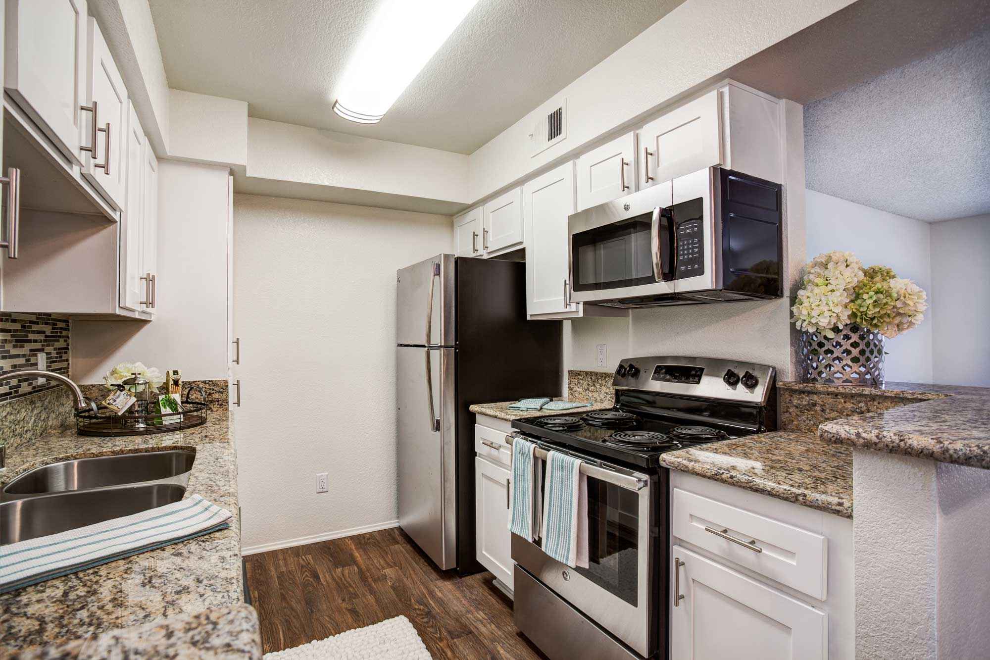 kitchen stainless steel microwave and stove at Waterstone