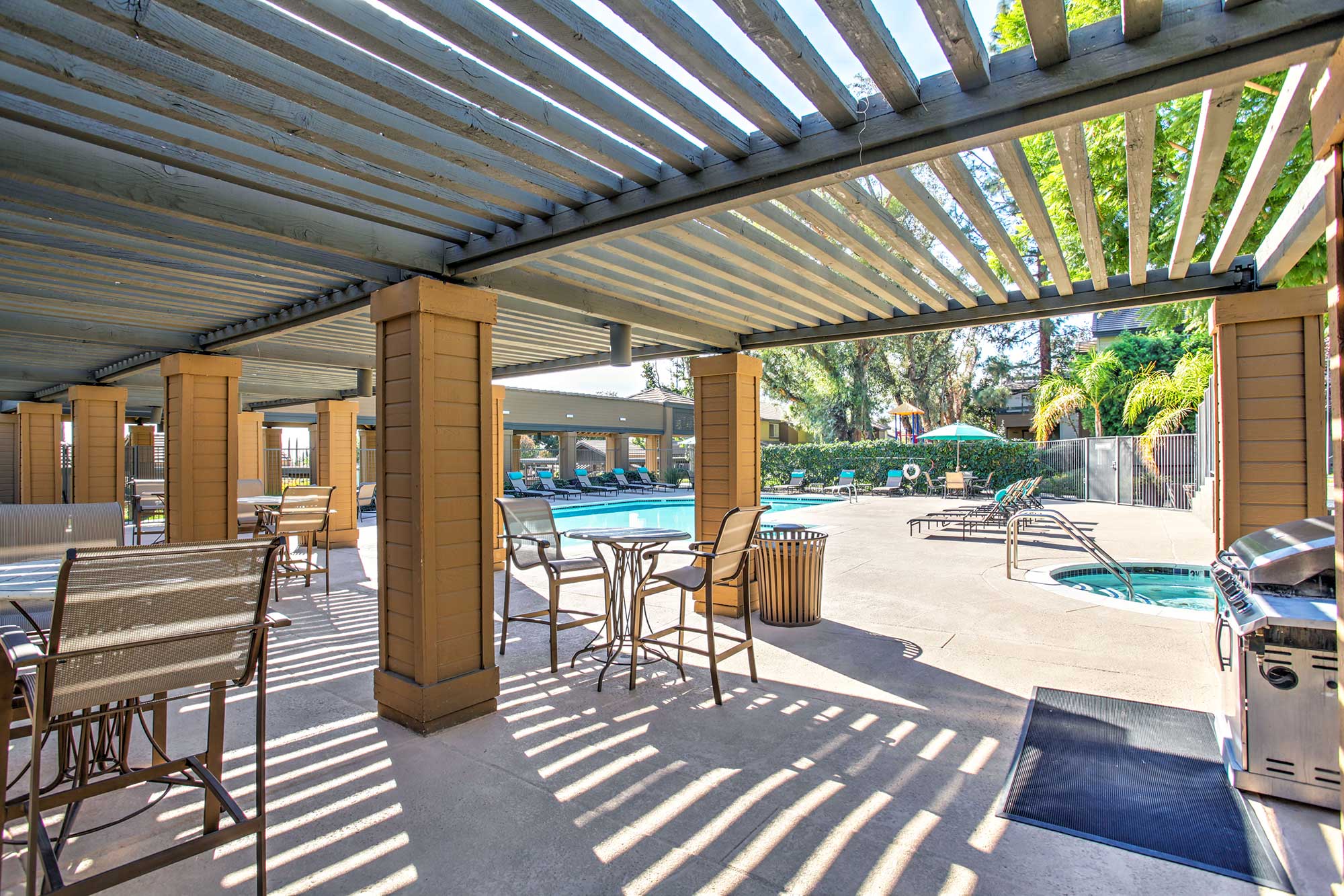 Waterstone Alta Loma Apartments community pool and lounge area with barbecue